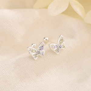 Silver butterfly screw back earrings with colorful cubic zirconia on beige fabric