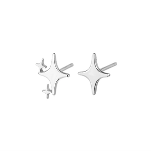 Polished silver asymmetrical star stud earrings with a minimalist four-pointed star design