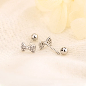Elegant silver bow stud earrings with sparkling zircons and secure screw back closure