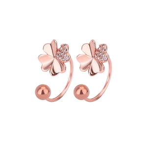 Detail of rose gold clover stud earrings with cubic zirconia and C-curve screw design