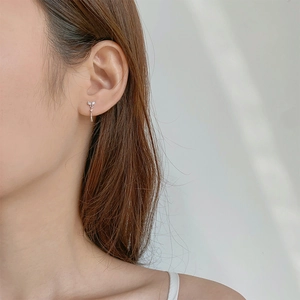 Elegant silver teardrop earrings with zircons shown on model for a minimalist summer look