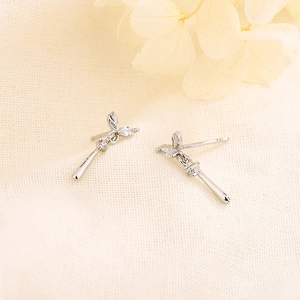 Elegant silver leaf drop earrings with sparkling marquise zircons on textured fabric
