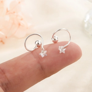 Minimalistische 925er Silber Stern-Ohrstecker mit Zirkon-Anhängern auf Fingerspitzen