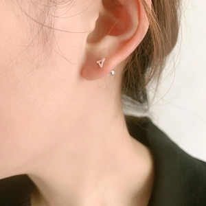 Minimalist silver triangle geometric stud earrings worn by model for modern look