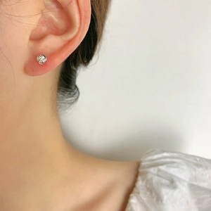 Silver rose stud earring featuring intricate floral petals shown on a female model