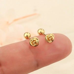 3D golden rose stud earrings with screw-back design shown on fingertips for size