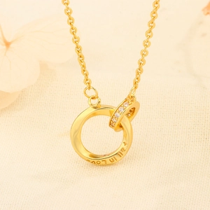 Gold Mobius necklace featuring interlocking rings with 'Fall in Love' engraving and zircon