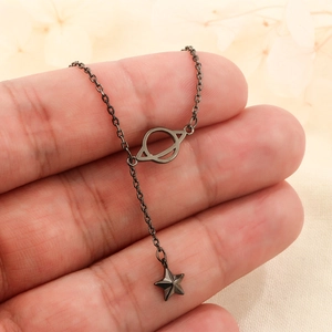 Dark gothic Saturn planet necklace with hanging star pendant on a black metal O-chain