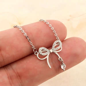 Exquisite silver bow necklace with sparkling zircon pavé and round crystal drop pendant