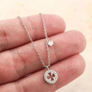 Silver four-leaf clover pendant necklace with sparkling cubic zirconia on a dainty chain