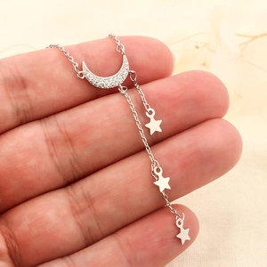 Exquisite silver star and moon necklace featuring sparkling zircons and tassels