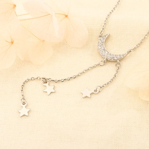 Elegant star and moon necklace with cubic zirconia moon pendant and tassel star charms