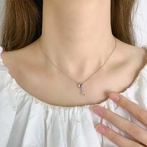 Elegant 925 sterling silver mermaid tail necklace with blue gemstone on model