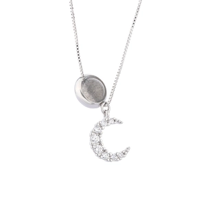 Detailed close-up of moonlight stone pendant and crescent moon with pavé set crystals