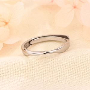 Polished silver Mobius band ring with a minimalist twist design and adjustable opening
