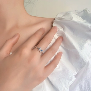 Detail of silver butterfly ring featuring light blue cubic zirconia and hollow wings