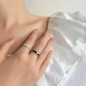 Minimalist black and white enamel couple rings with elegant silver twist design