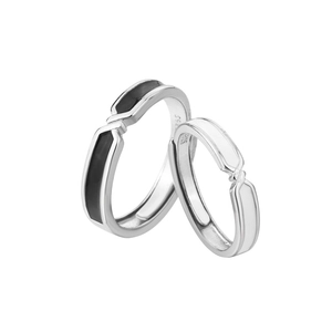 Close-up of S925 sterling silver couple rings with minimalist black and white enamel finish