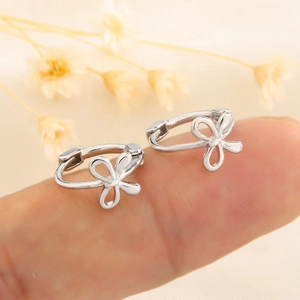 Polished silver bow earrings for women featuring a minimalist openwork bow design