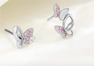 Macro shot of S925 asymmetric pink butterfly studs with glittering cubic zirconia