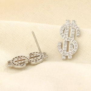Macro shot of S925 sterling silver stamp on crystal-encrusted dollar sign stud earrings