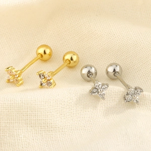 Detail of flower stud earrings with sparkling cubic zirconia in gold and silver finish
