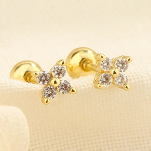 Detailed macro view of gold-plated flower stud earrings with zircon and screw back