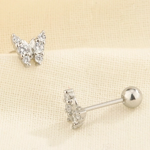 Macro shot of butterfly cartilage stud earrings with sparkling cubic zirconia and ball back