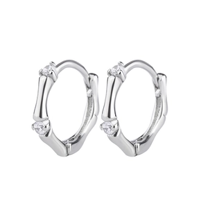 Macro shot of silver bamboo style earrings featuring sparkling cubic zirconia stones