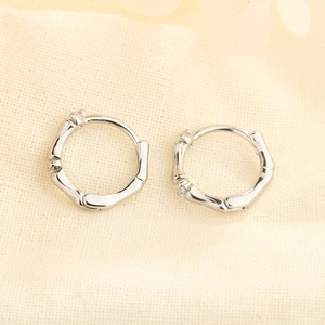 S925 silver bamboo-style huggie hoop earrings with white zircon on textured fabric