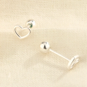 Elegant S925 silver hollow heart stud earrings with secure screw-back on beige fabric