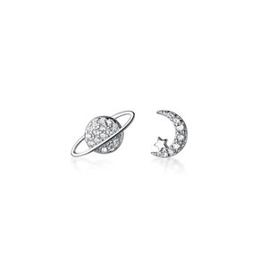Macro shot of asymmetric planet and moon earrings with sparkling zircon pave and silver finish