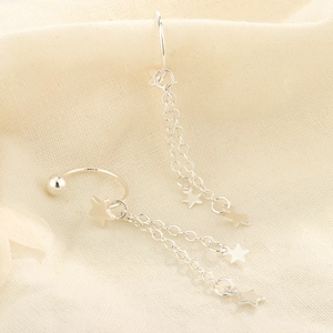 Macro view of S925 sterling silver star stud earrings with delicate hanging tassels
