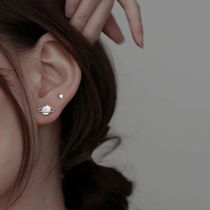 Asymmetric S925 silver planet and moon stud earrings featuring shimmering crystals on model