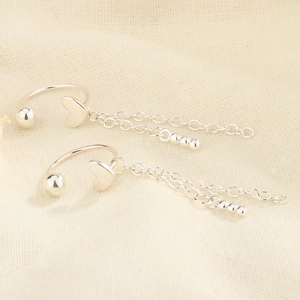 Silver heart cuff earring detail with double fringe chains and polished beads finish