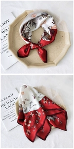 Detail of red and white silk square scarf featuring retro floral and bird illustrations