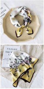 Detail of silk square scarf featuring floral and shell patterns on lace background