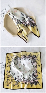 Macro detail of ginger silk scarf featuring botanical prints and satin finish texture