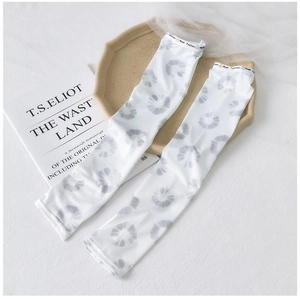 Detail of white ice silk sun sleeves featuring grey floral ink print and elastic band