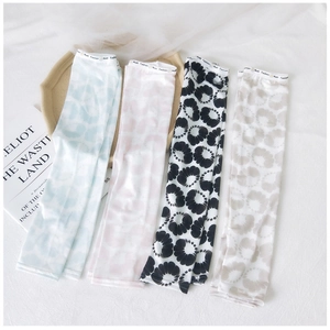 Close-up of cooling ice silk sun sleeves with floral ink patterns and elastic cuffs