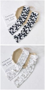 Detail of floral ink patterns and anti-slip elastic cuffs on ice silk cooling sleeves