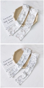 Detail of floral ink-pattern cooling ice silk arm sleeves with elastic fashion wristbands