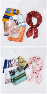 Detail of printed silk-like square scarf featuring classic equestrian and paisley patterns