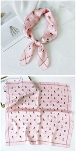 Detail of pink satin square scarf with dog print and geometric pattern border