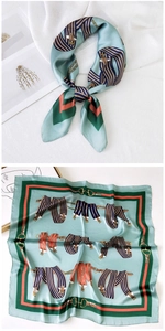 Detail of mint green square silk scarf with classic equestrian belt and chain pattern print