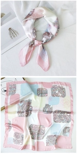 Detail of pink silk square scarf with paisley and rose patterns in a flat and knotted view