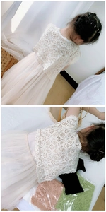 Detail of floral lace shawl showing intricate circular flower patterns and wavy hem edge