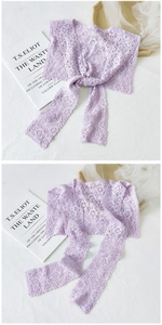 Detail of light purple lace shawl with floral embroidery and tassel tie closure