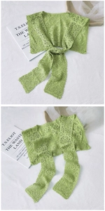 Detail of light green lace floral shawl with delicate hollow embroidery and soft texture