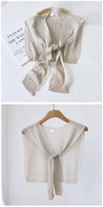 Detail von apricotfarbenem Strickschal mit feinen Rippen und passendem Bindeband